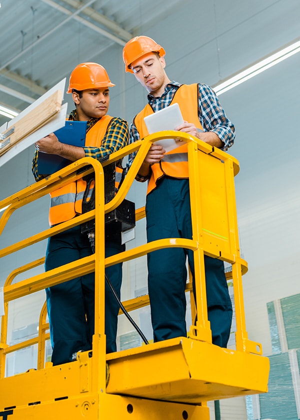 two men in a scissor lift